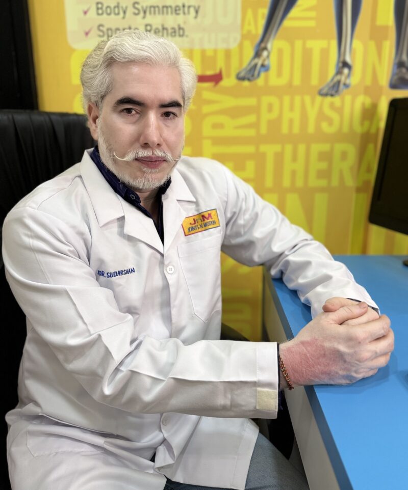 Dr Sudarshan Singh performing spinal adjustment chiropractic treatment chronic back pain Thane clinic